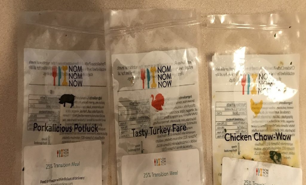 three packages of nomnomnow gently cooked dog food