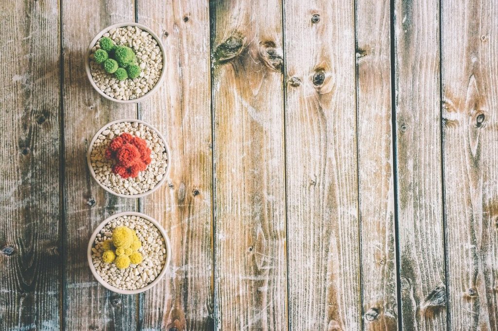 natural canine arthritis treatments-natural botanicals in a bowl on wood background