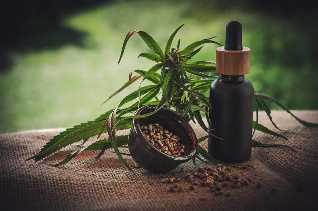 cbd oil brands, cannabis and bottle with stopper